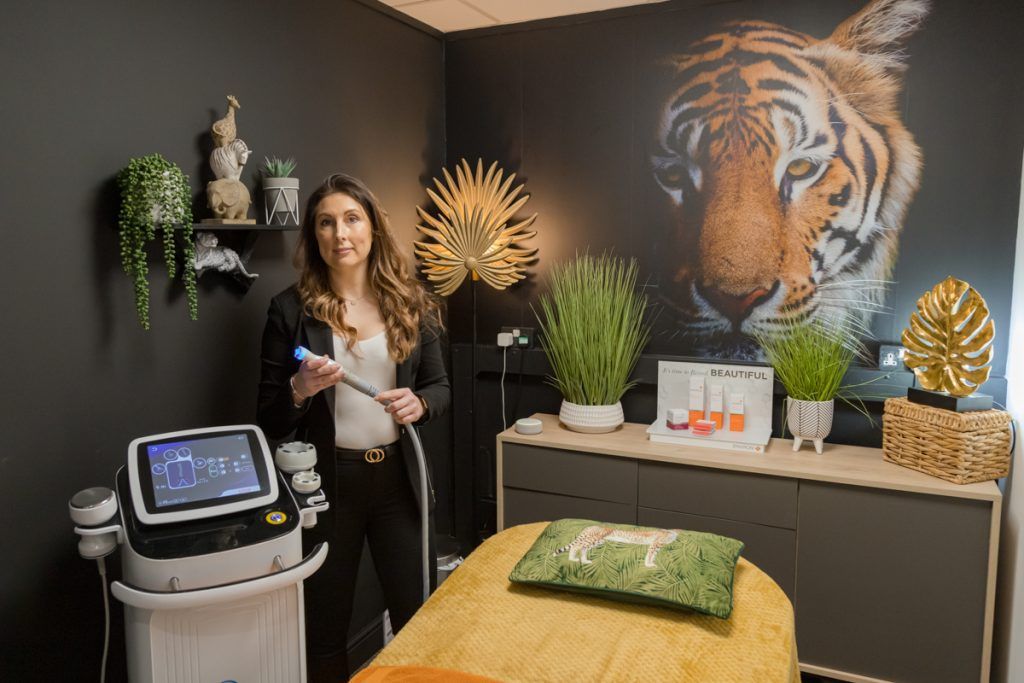 Female beauty therapist in empty treatment room