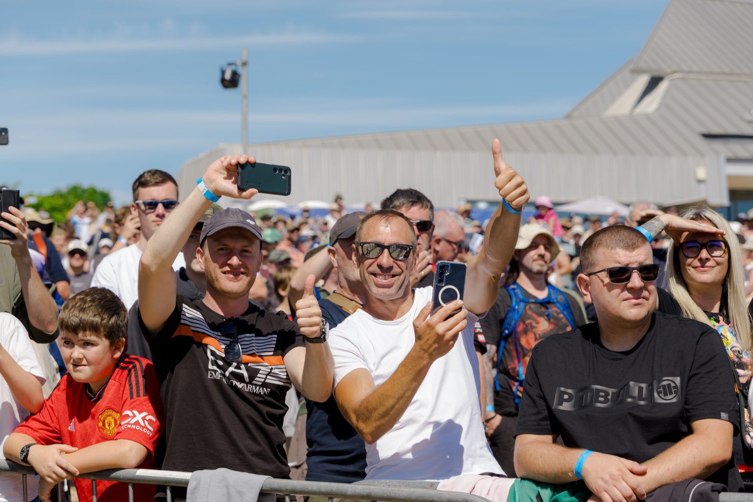 Crowd smiling and putting thumbs up