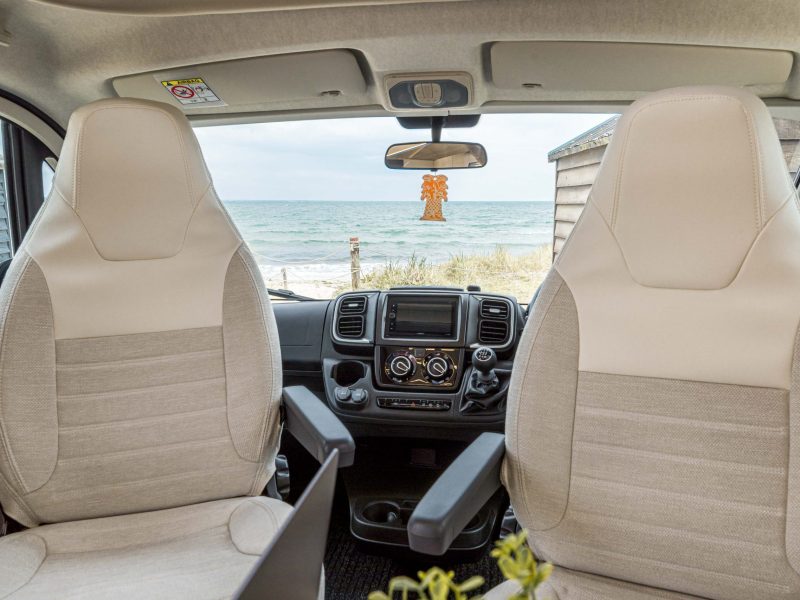 Interior seats of camper-van parked by the beach