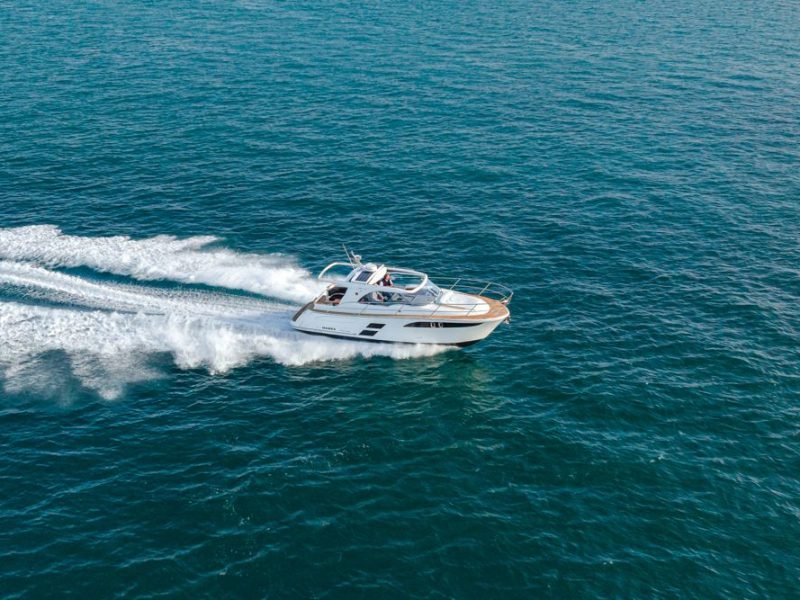 Boat moving at speed with wake behind