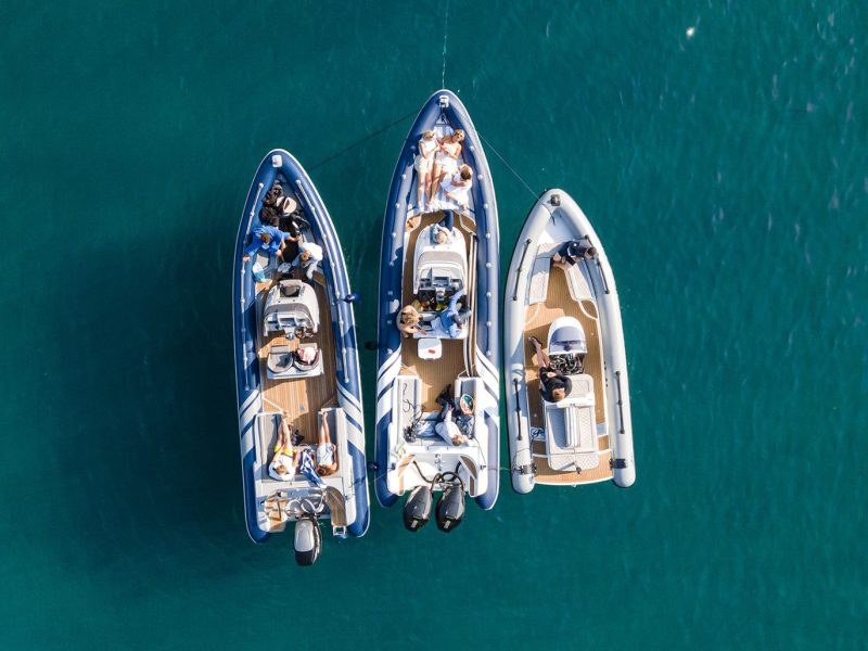 Three boats moored together at sea