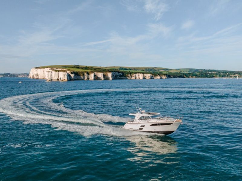 Boat banking during a turn with cliffs behind