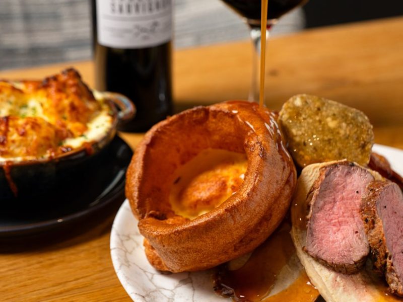 Beef roast with gravy being poured on top