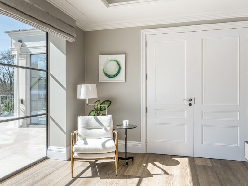 Sunlight coming through windows across armchair and door