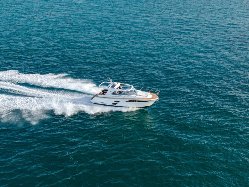 Boat traveling on water with wake behind